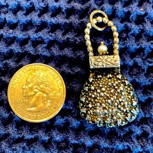 Pendant that can also be worn as a pin.